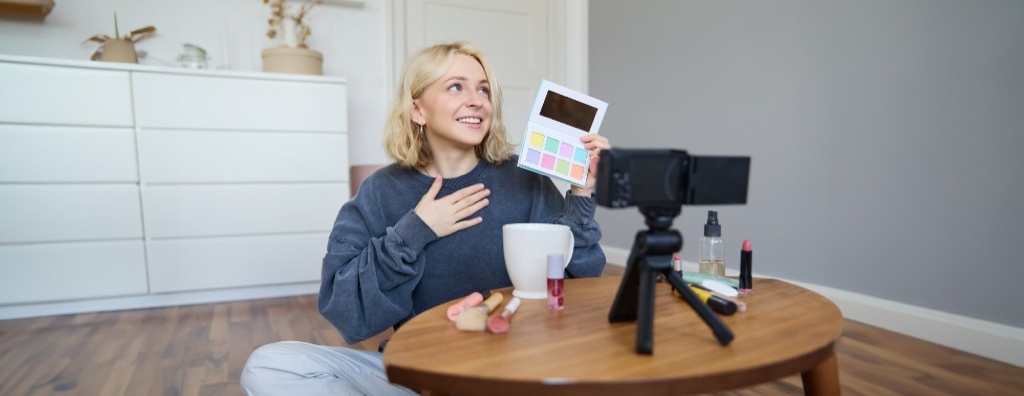 Lifestyle creator filming a video with makeup products and a camera on a tripod