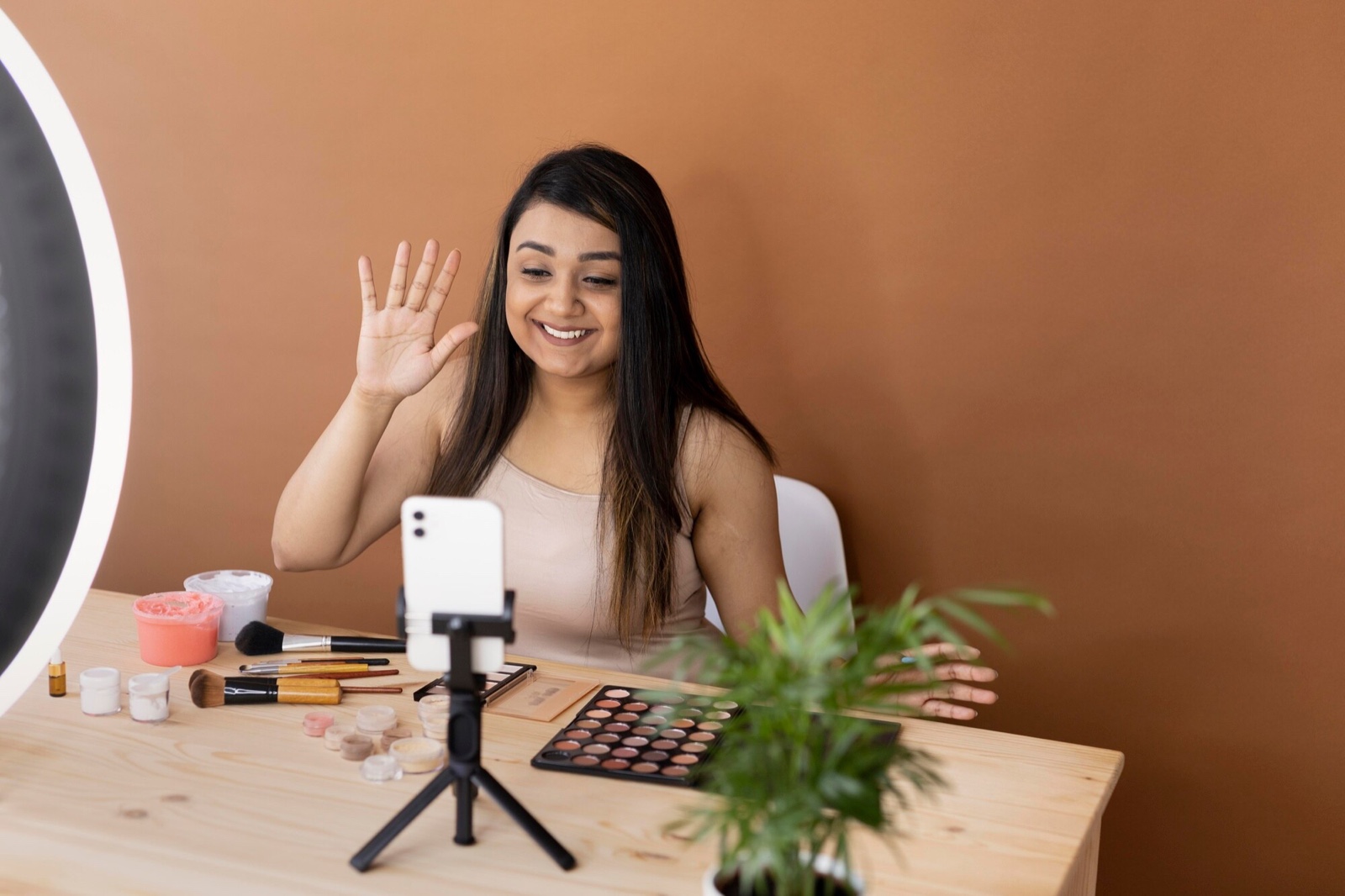 Creator waving during a phone recording
