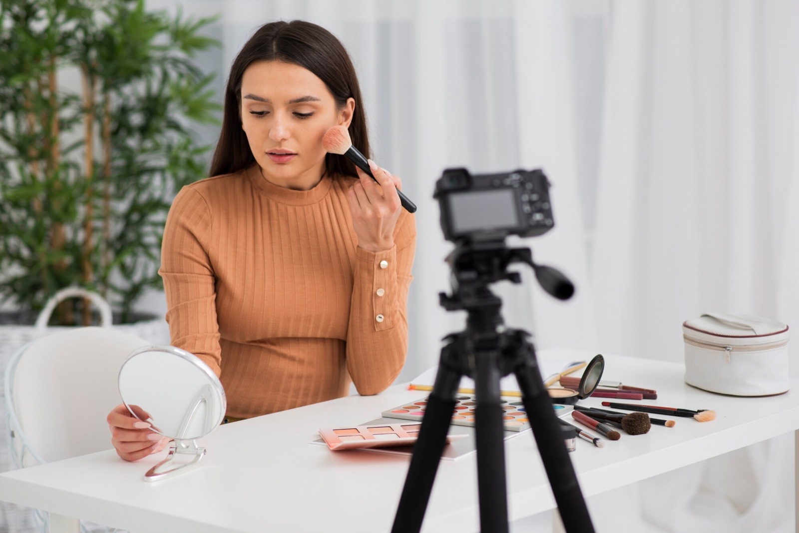 Creator applying makeup in front of a camera